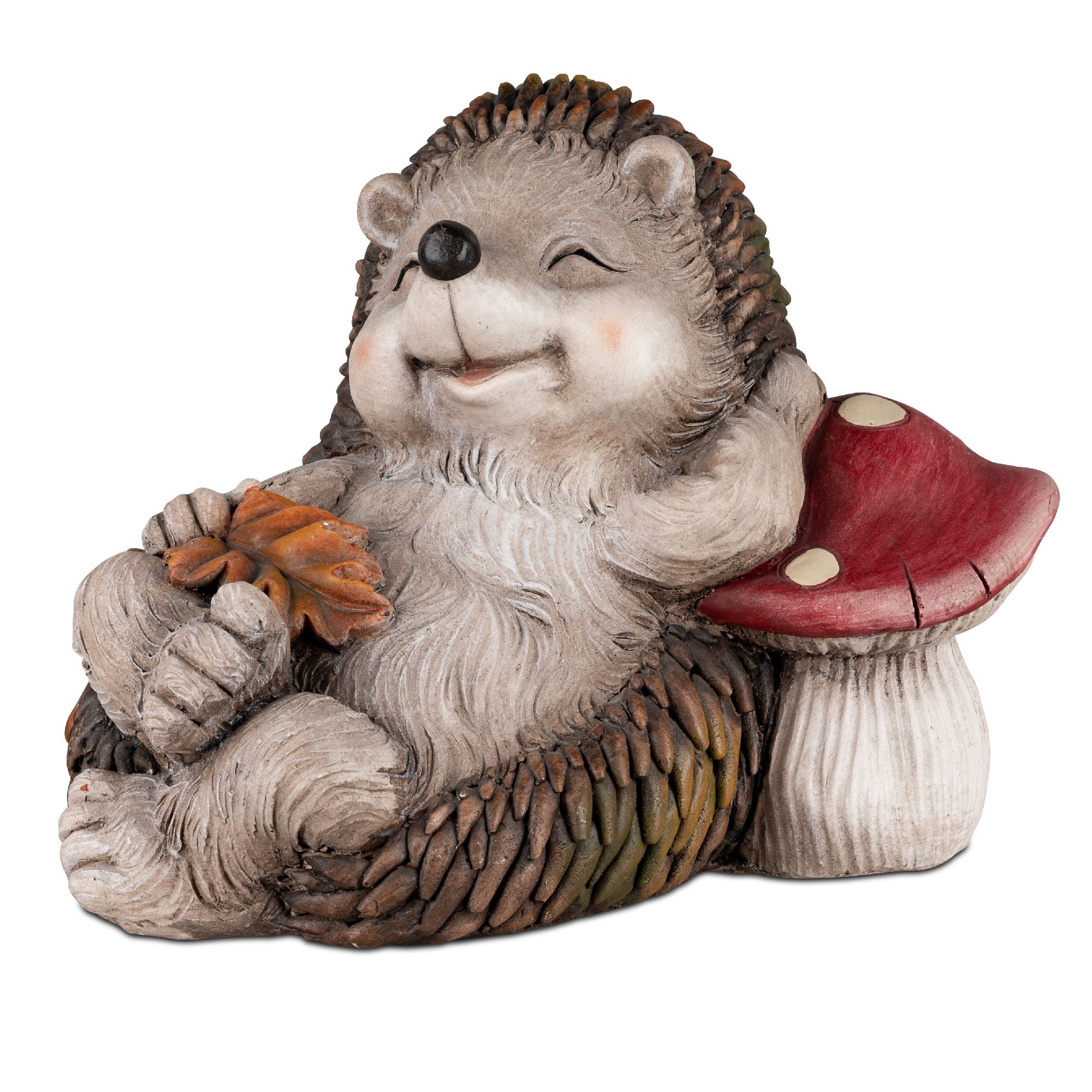 Eine sitzende, lächelnde Igelfigur mit einem Blatt in der Hand, neben einem roten Fliegenpilz. Die F
