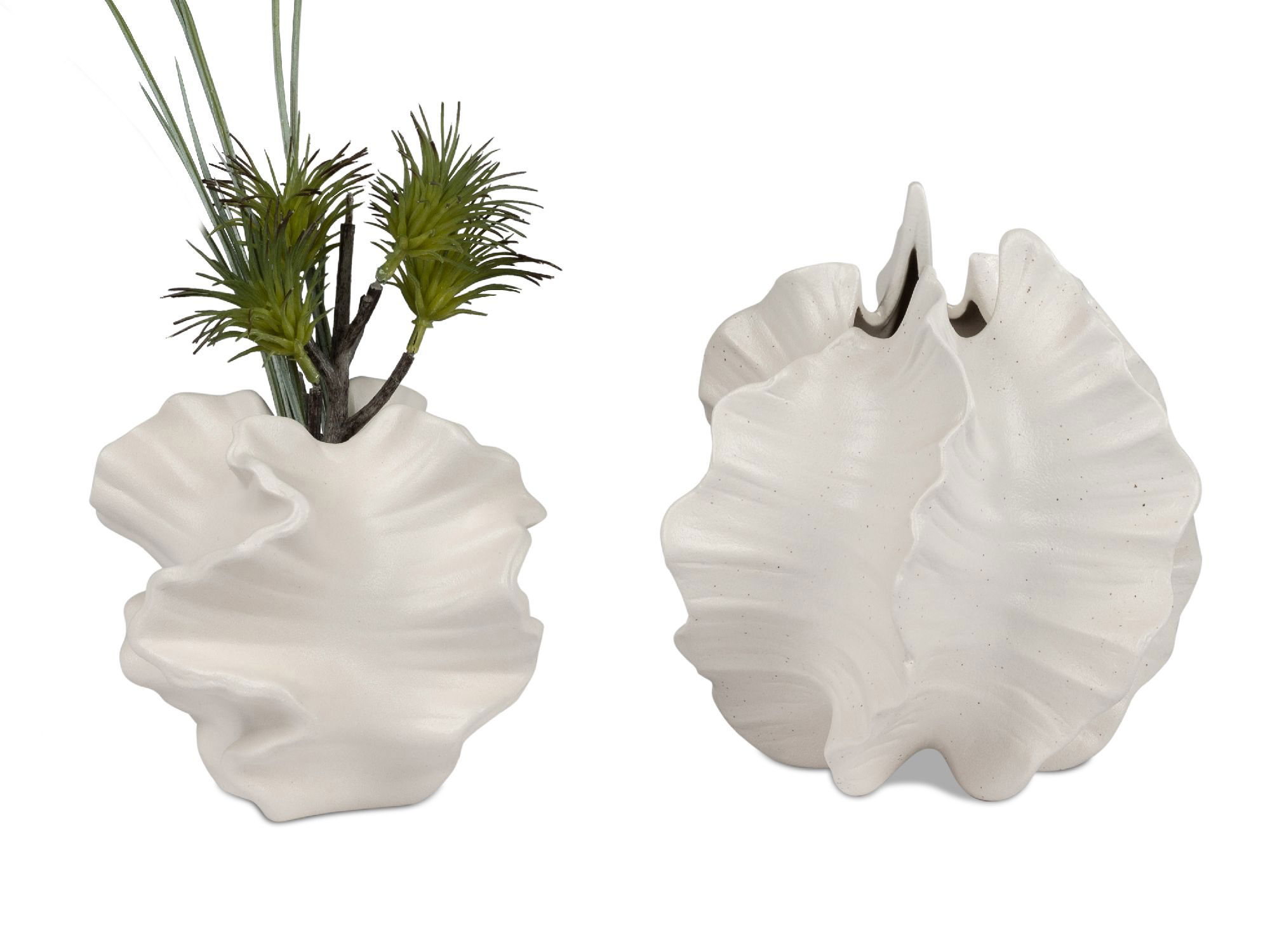 Zwei weiße Vasen in Muschelform, eine mit künstlichen Pflanzen, die andere offen und glatt. Beide haben eine strukturierte Oberfläche.