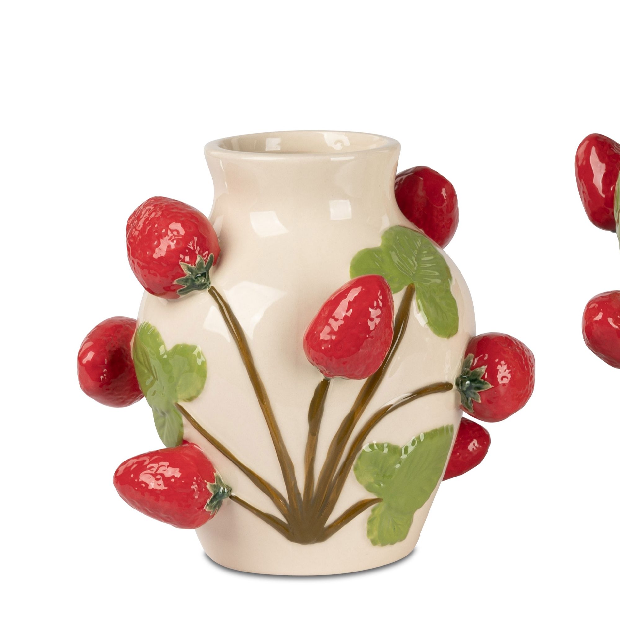 Vase in cremefarben mit roten Erdbeeren und grünen Blättern, dekorativ angeordnet.