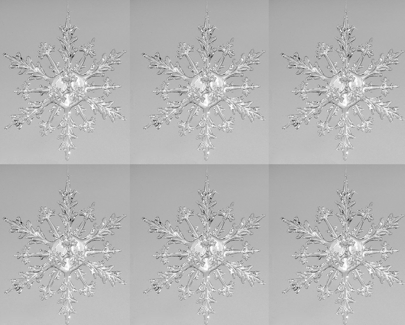 Sechs transparente Schneeflocken auf grauem Hintergrund, symmetrisch angeordnet, mit filigranen Deta