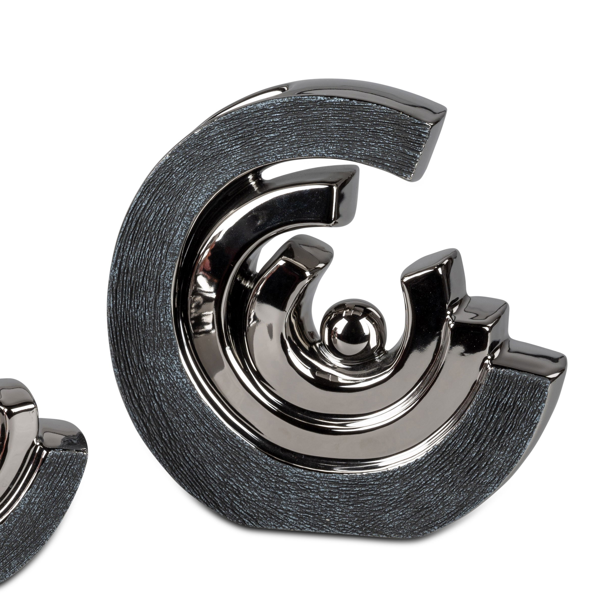 Zwei dekorative Objekte in spiralförmigem Design, aus glänzendem Material mit strukturierten Oberflächen.