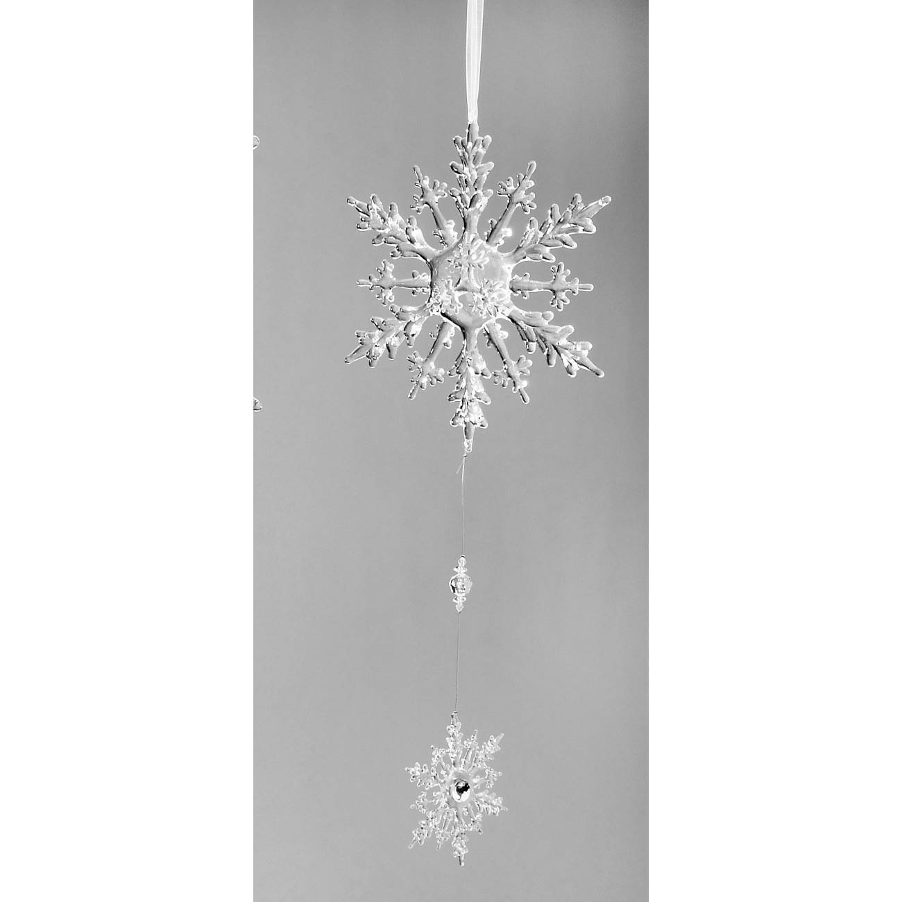 Hängende Schneeflocken aus Kunststoff, eine größere oben und eine kleinere unten