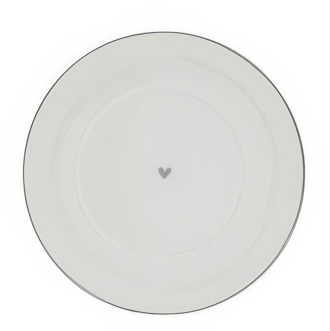 Ein runder, weißer Teller mit einem schmalen Rand und einem kleinen, grauen Herz in der Mitte.