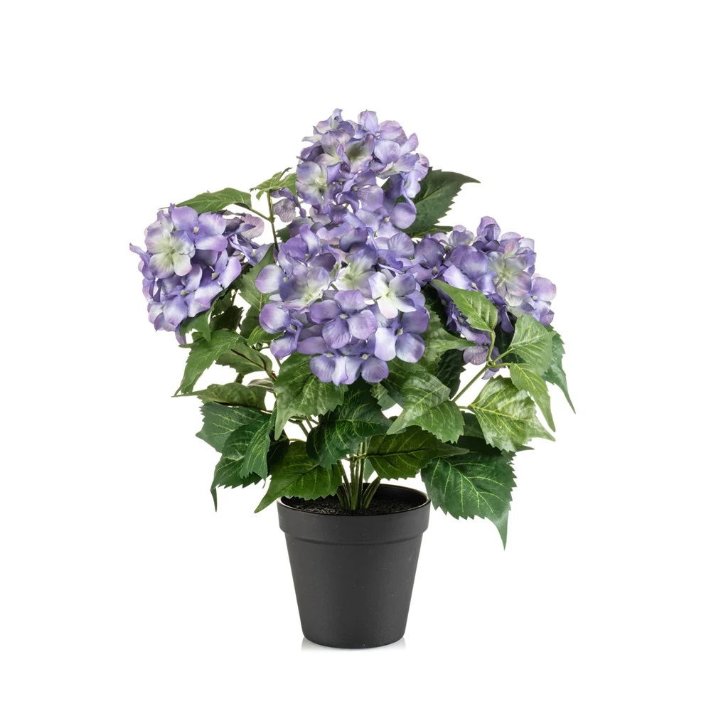 Kunstpflanze mit lila Blüten und grünen Blättern in einem schwarzen Blumentopf.