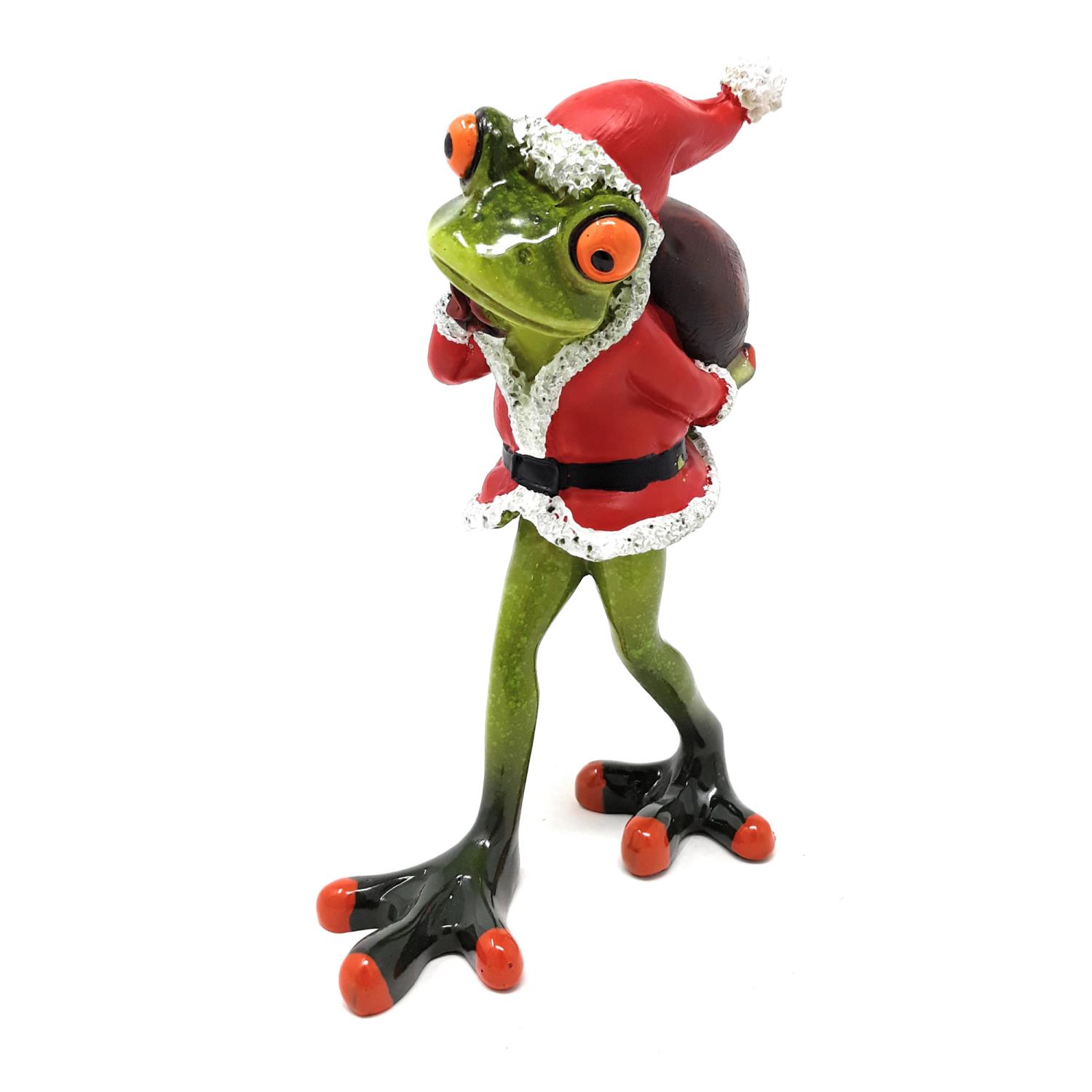 Eine grüne Froschfigur trägt einen roten Weihnachtsmannanzug und einen roten Hut. Sie hält einen Sac