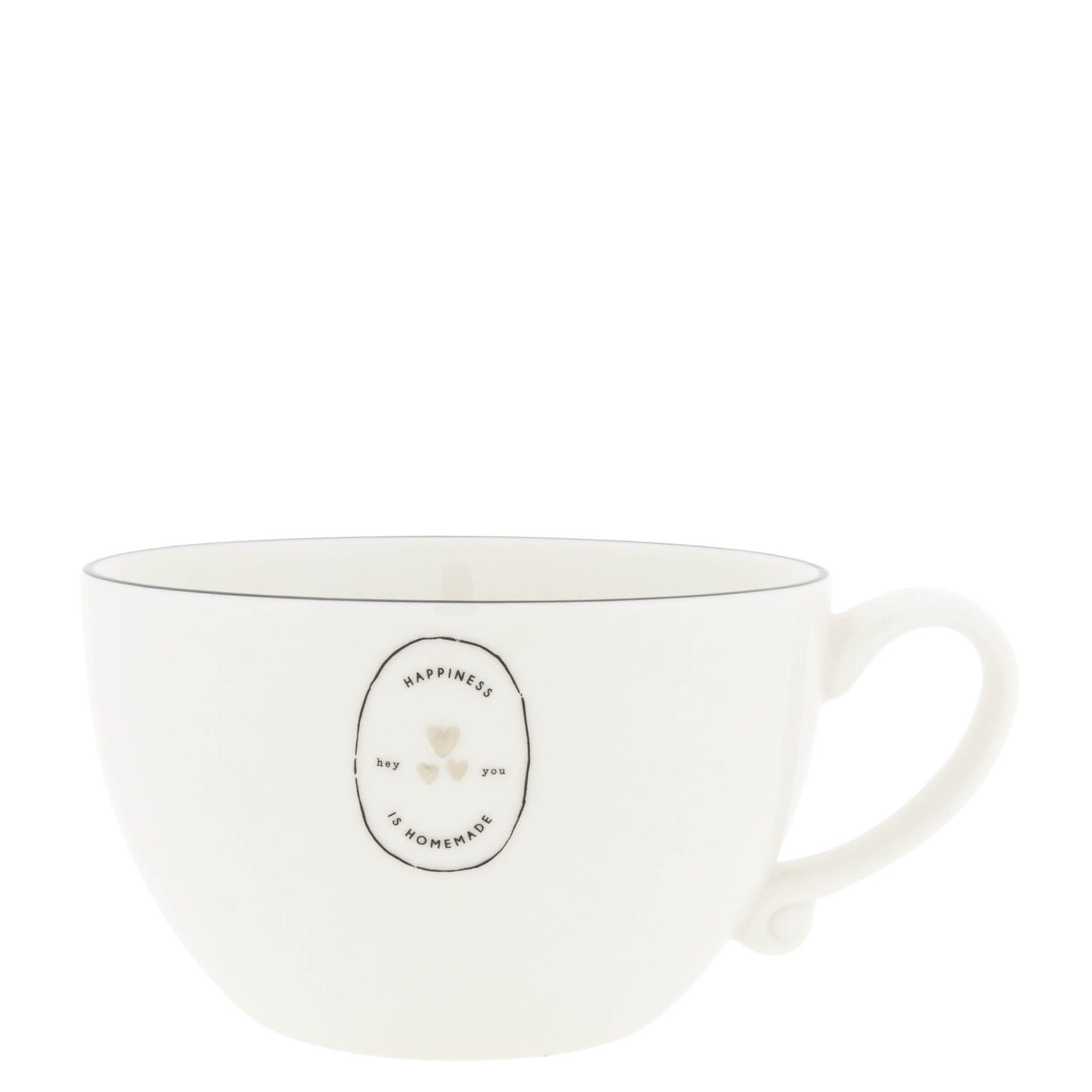 Weiße Tasse mit einem ovalen Aufdruck, der die Worte „Happiness is homemade“ und zwei Herzen zeigt.