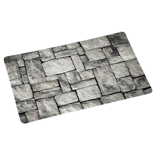 Grau gemusterte Matte mit einem Design aus rechteckigen Steinen in verschiedenen Größen und Schattierungen.